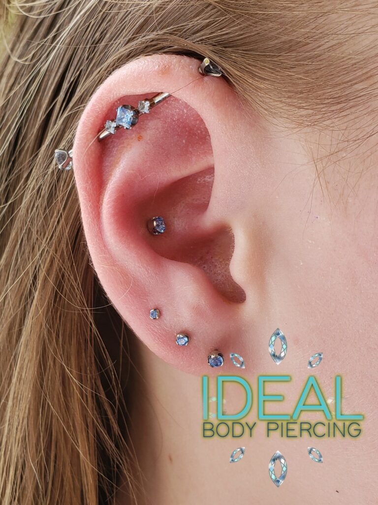 A woman 's ear with multiple piercings and an arrow.