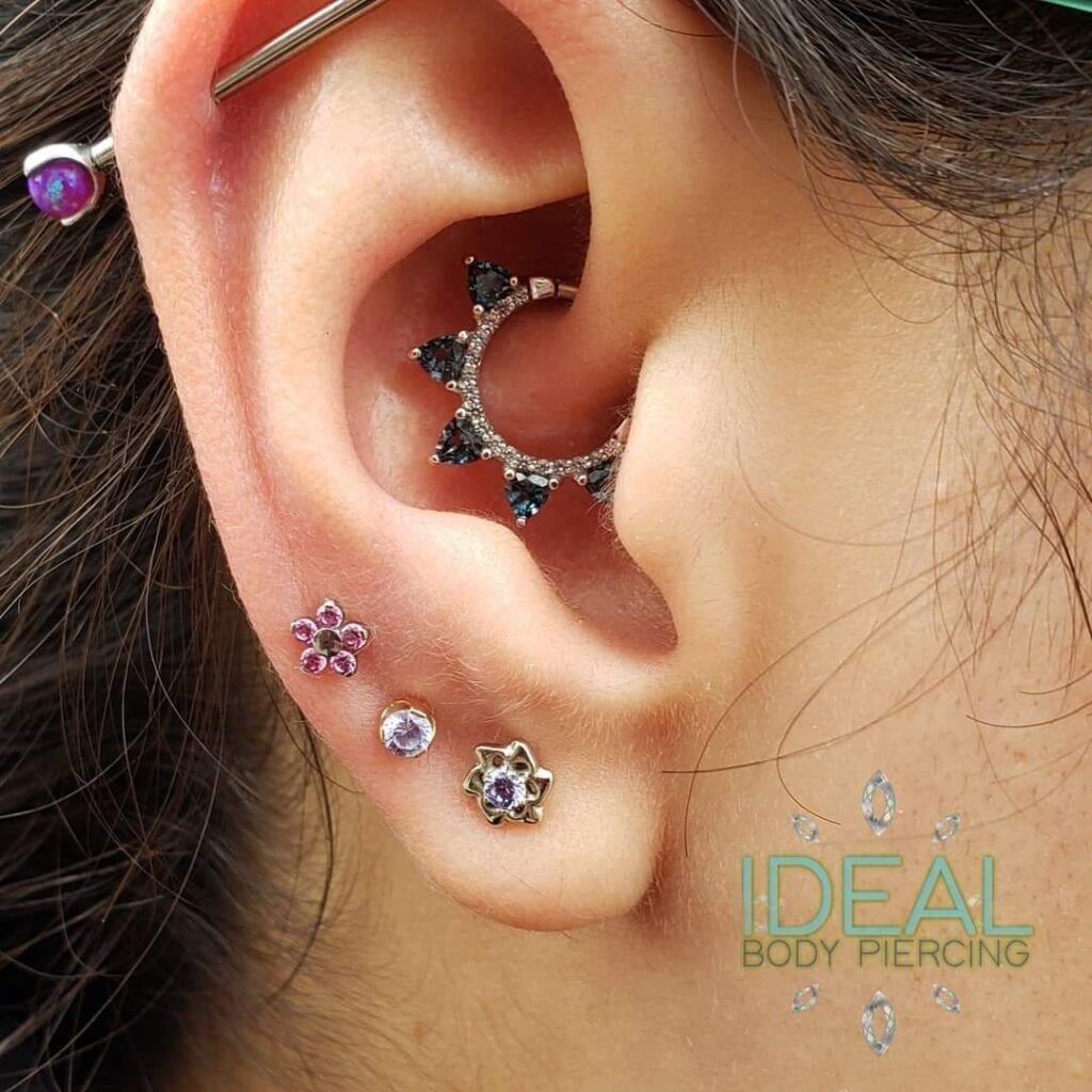 A woman with multiple piercings and an ear piercing.