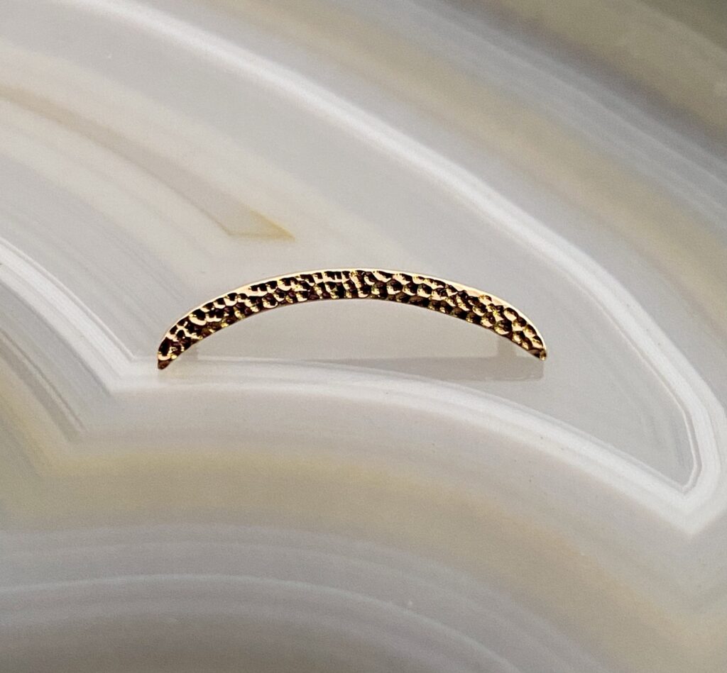 A close up of the side of a gold bracelet